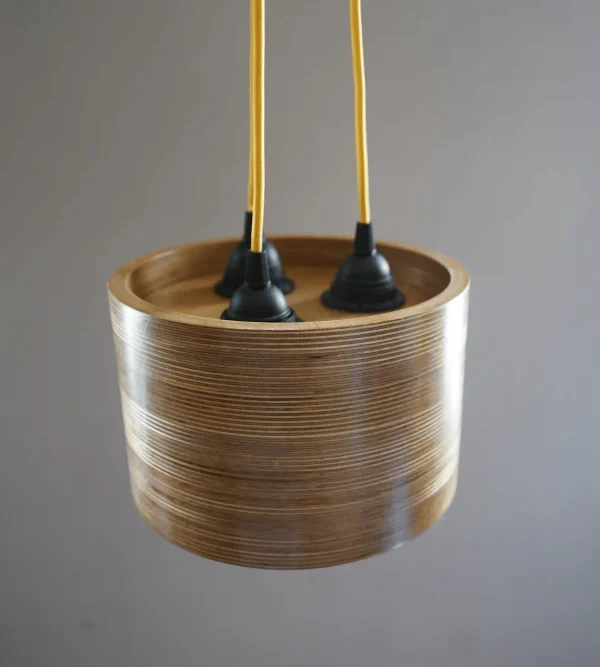 3 Bulb Round Pendant Light made of layered birch plywood with a smooth finish, suspended by a yellow fabric cable.