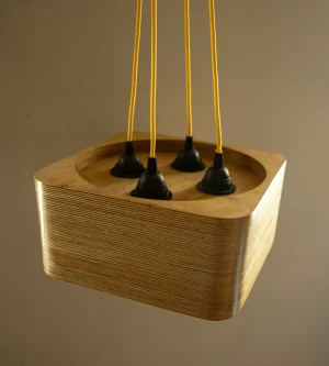 Quad Bulb Square Pendant Light made of layered birch plywood with a smooth finish, suspended by a yellow fabric cable.