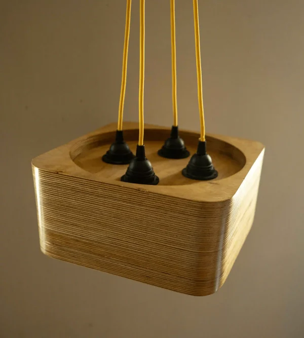 Quad Bulb Square Pendant Light made of layered birch plywood with a smooth finish, suspended by a yellow fabric cable.